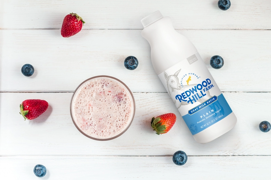 a container and a glass of Redwood Hill farm kefir with berries